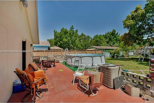 view of patio with a fenced in pool