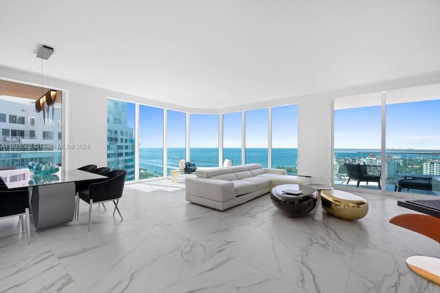 sunroom featuring a water view