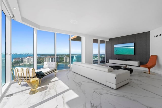 living room with a healthy amount of sunlight and floor to ceiling windows