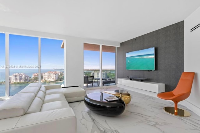 living room featuring a water view and floor to ceiling windows