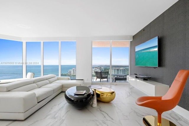 living room featuring floor to ceiling windows and a water view