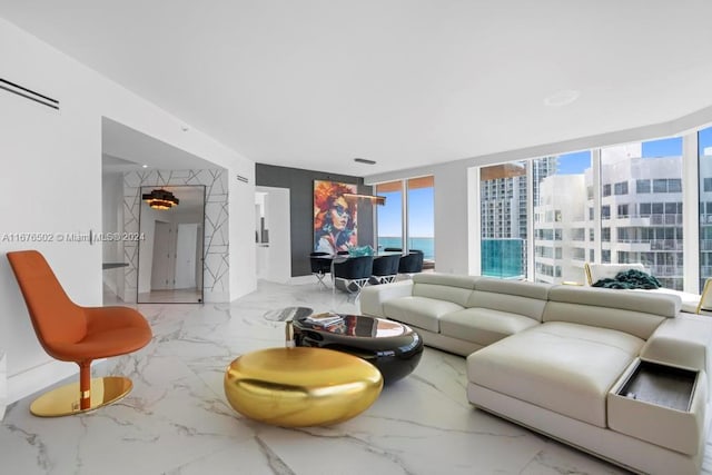 living room with a water view and a wall of windows