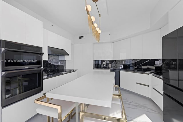 kitchen with black appliances, hanging light fixtures, white cabinetry, decorative backsplash, and exhaust hood