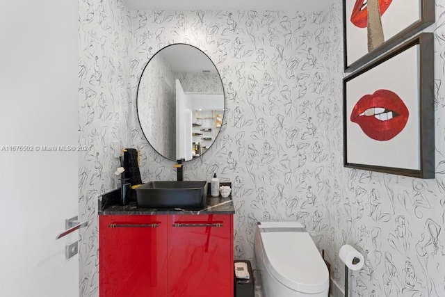 bathroom featuring vanity and toilet