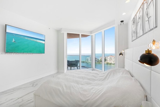 bedroom with access to exterior and a water view