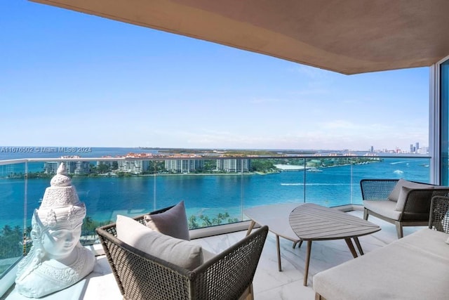 balcony with a water view and an outdoor living space