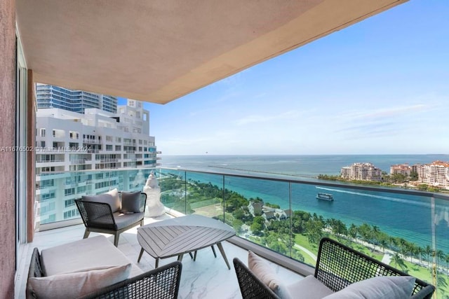 balcony featuring a water view and an outdoor hangout area