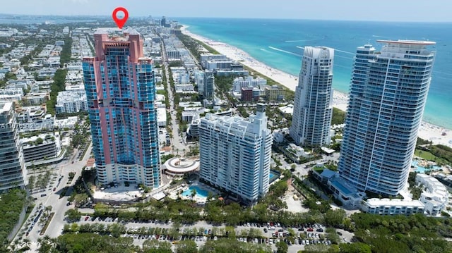 drone / aerial view featuring a water view and a beach view