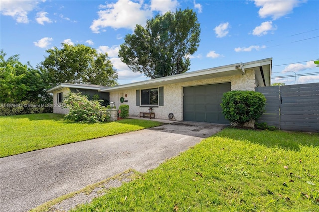 ranch-style home with a front yard and a garage