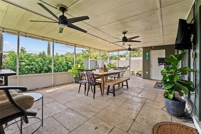 sunroom with ceiling fan and plenty of natural light