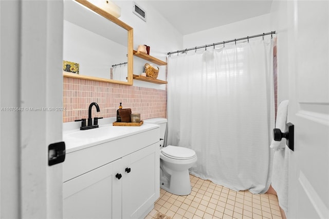 bathroom featuring toilet, tile patterned flooring, backsplash, curtained shower, and vanity