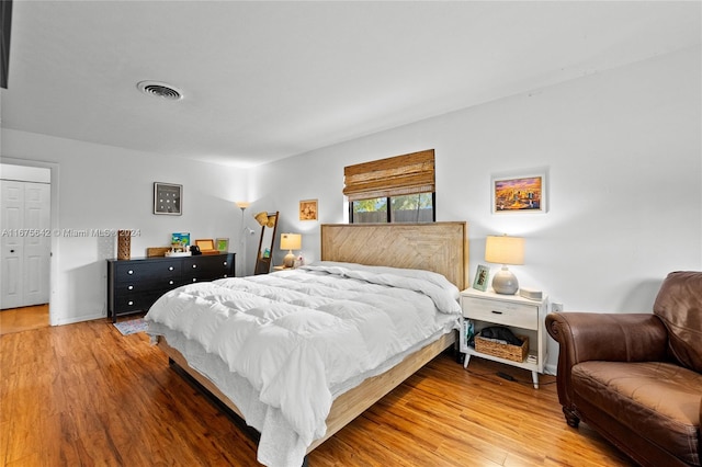 bedroom with hardwood / wood-style flooring