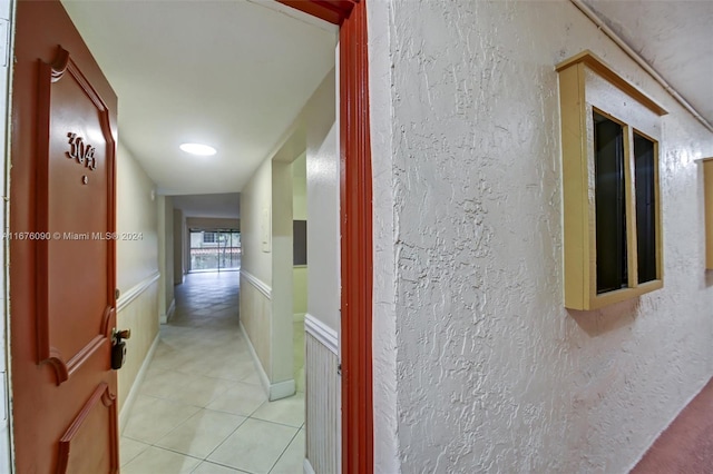 corridor with light tile patterned floors