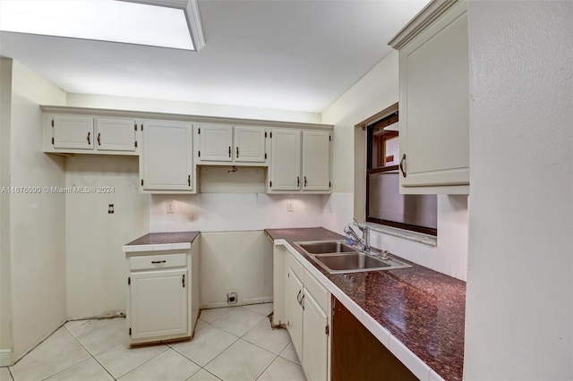 kitchen with light tile patterned floors and sink