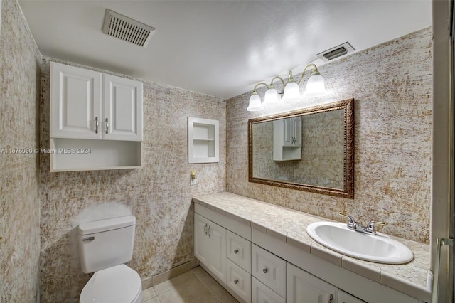 bathroom with vanity, toilet, and tile patterned floors