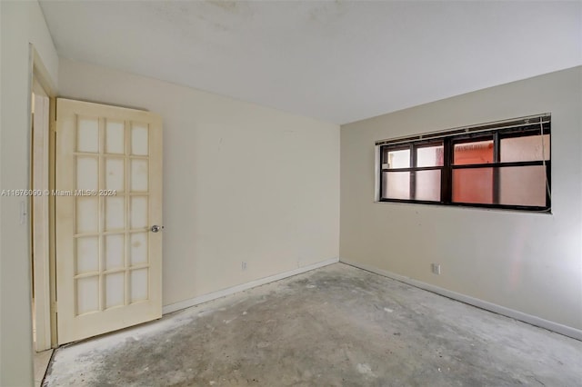 spare room with concrete flooring