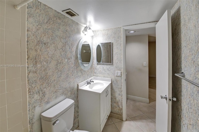 bathroom featuring tile patterned floors, vanity, and toilet