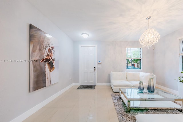 entrance foyer with an inviting chandelier and light tile patterned floors