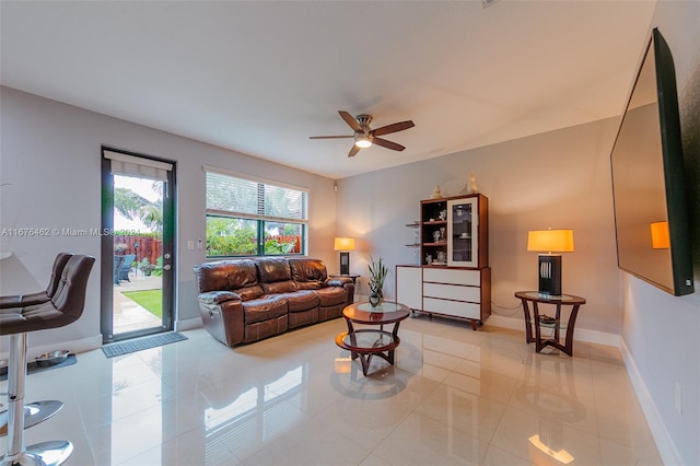 tiled living room with ceiling fan