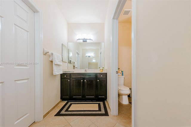 bathroom featuring tile patterned floors, vanity, and toilet