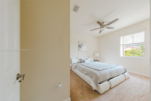 bedroom featuring ceiling fan and light colored carpet