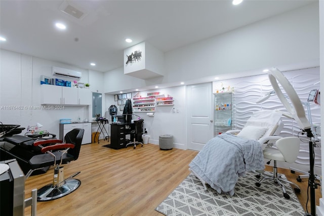 office area featuring light hardwood / wood-style floors and a wall unit AC