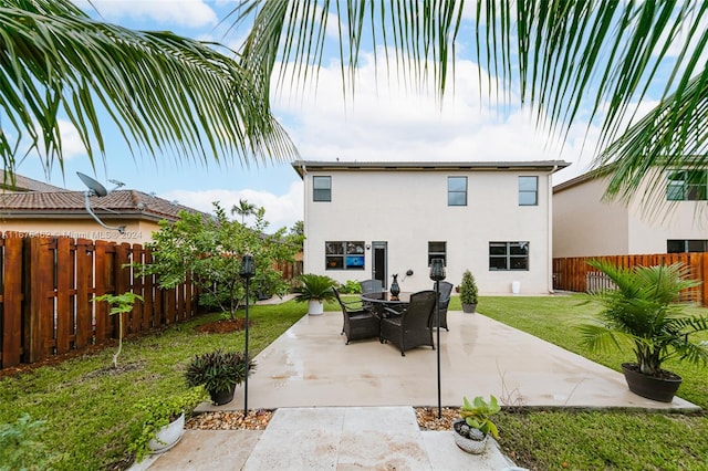 back of house with a patio and a lawn