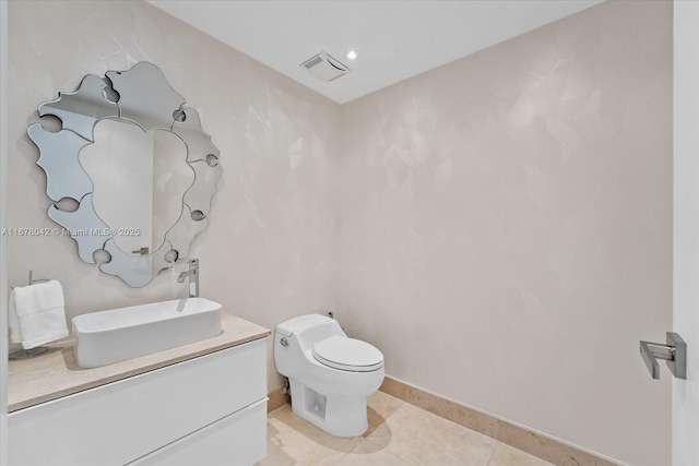 bathroom with tile patterned flooring, vanity, and toilet