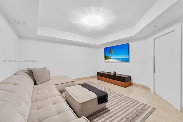 living room featuring a tray ceiling