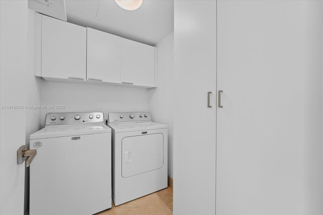 clothes washing area featuring separate washer and dryer, light tile patterned floors, and cabinets