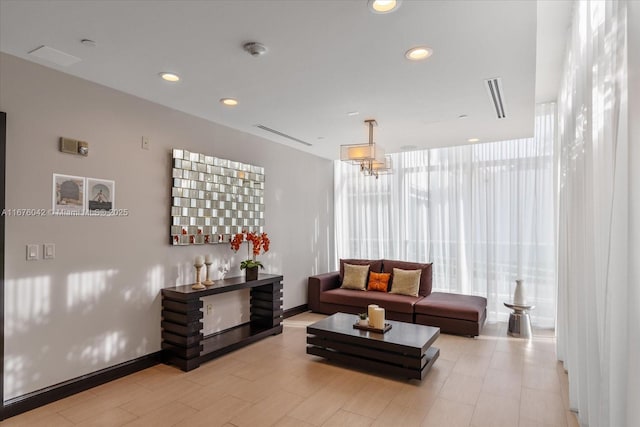 living room with expansive windows and an inviting chandelier