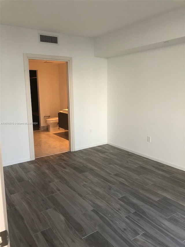 spare room with dark hardwood / wood-style flooring