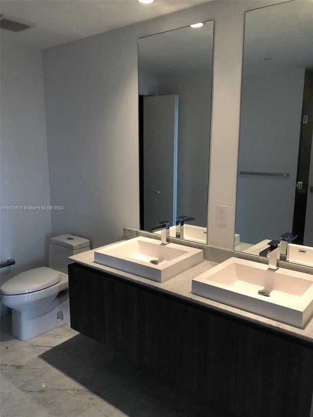 bathroom featuring vanity and toilet