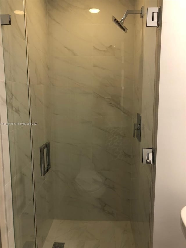 bathroom featuring a shower with shower door