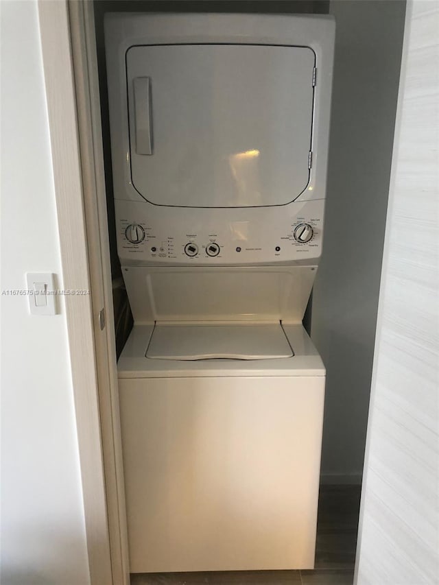 laundry area featuring light hardwood / wood-style floors and stacked washer / dryer