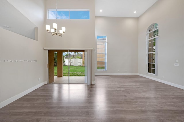 foyer entrance with a high ceiling, a chandelier, and dark hardwood / wood-style flooring