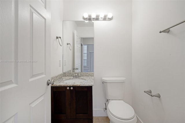 bathroom featuring vanity, toilet, and tile patterned flooring