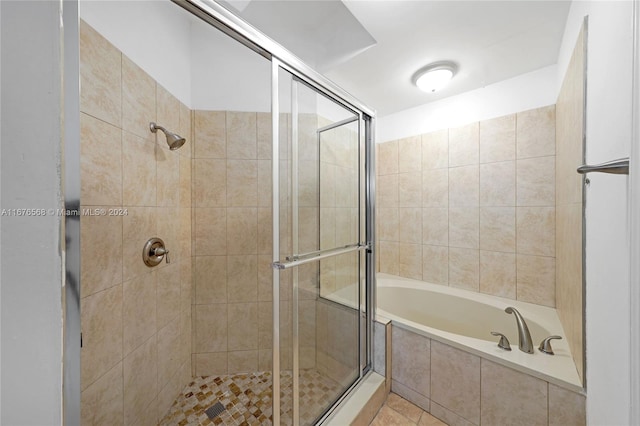 bathroom with tile patterned floors and shower with separate bathtub