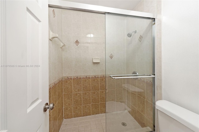 bathroom featuring toilet and walk in shower