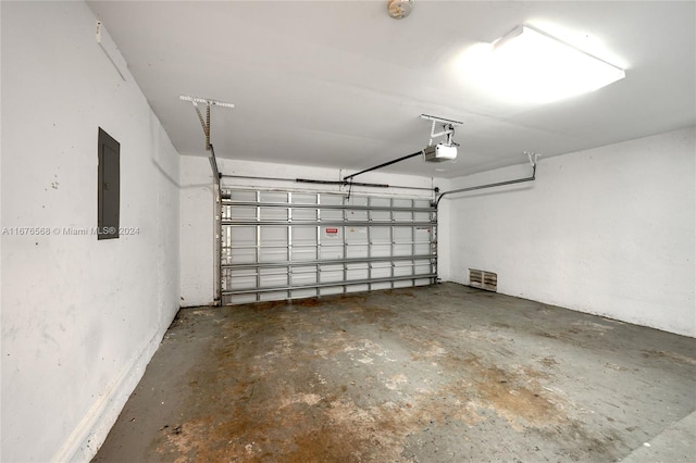 garage featuring a garage door opener and electric panel