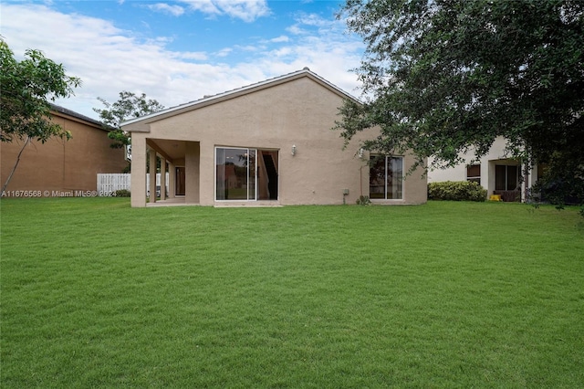 back of house with a yard