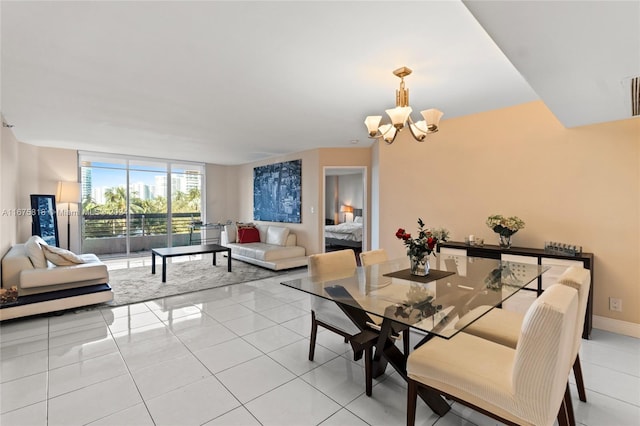 dining space featuring a notable chandelier and light tile patterned floors