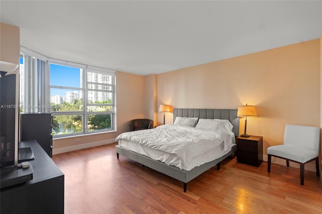 bedroom with hardwood / wood-style flooring