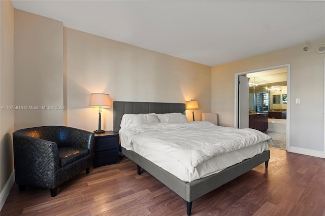 bedroom featuring hardwood / wood-style flooring and ensuite bathroom