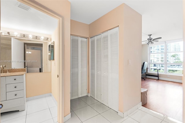 interior space with tile patterned flooring, vanity, and ceiling fan