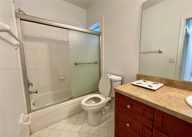 full bathroom with tile patterned floors, vanity, toilet, and enclosed tub / shower combo