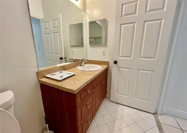 bathroom featuring tile patterned floors, vanity, and toilet