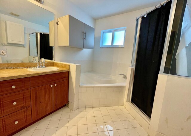 bathroom with plus walk in shower, tile patterned flooring, and vanity