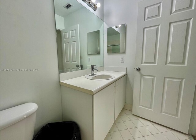 bathroom featuring tile patterned floors, vanity, and toilet