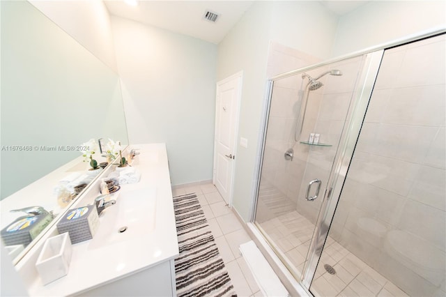 bathroom with tile patterned floors, vanity, and walk in shower